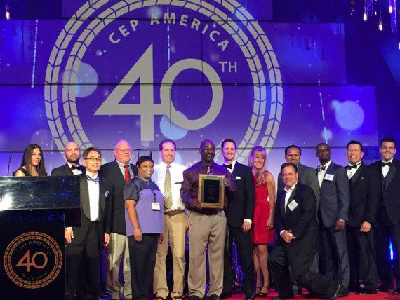 Dr. Imamu Tomlinson holding award, along with network employees 